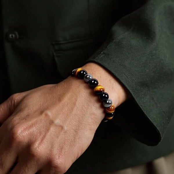 Triple Protection Bracelet 8 mm on wrist, grounding and confidence crystals Obsidian, Hematite and Tigers Eye