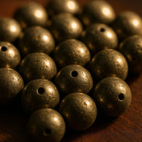 Close up bowl of natural Pyrite 8 mm loose beads showing metallic shine